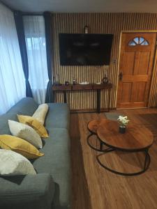 a living room with a couch and a table at Mary y Luis in Coihaique