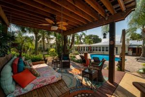 an outdoor living room with a couch on a patio at The Poolside Cottage -Wifi Pool in Jacksonville