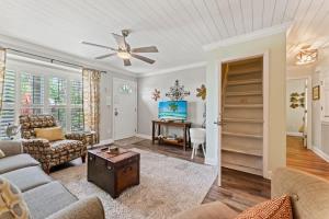 a living room with a couch and a ceiling fan at The Poolside Cottage -Wifi Pool in Jacksonville +22 photos