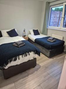 a bedroom with two beds and a window at Bellfield Views in Dundee