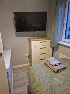 a bedroom with a bed and a flat screen tv at Bellfield Views in Dundee