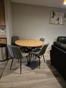 a table and chairs in a room with a couch at Bellfield Views in Dundee