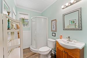 a bathroom with a shower and a toilet and a sink at The Poolside Studio - Lounge Pool Wifi in Jacksonville +28 photos