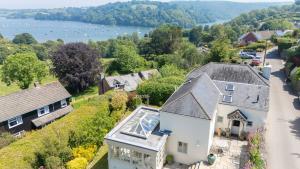 an aerial view of a house and a neighborhood at Dart View Cottage - A Stunning Riverside Escape in the Heart of South Devon in Dittisham