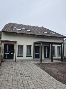 a house with a brick driveway in front of it at Comfort Collection Waldviertel in Litschau