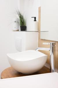 a bathroom with a white bowl sink on a counter at Starview by MD apartments in Ljubljana
