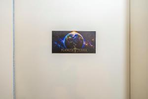 a picture of a planet on a wall at Sottam Hostel in Curitiba