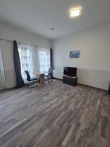 an empty room with a desk and chairs and a table at Comfort Collection Waldviertel in Litschau