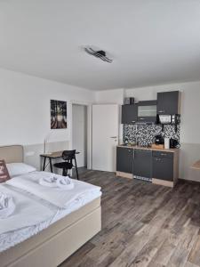 a bedroom with a large bed and a table at Comfort Collection Waldviertel in Litschau