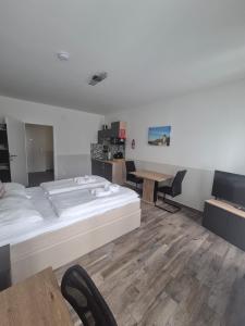 a bedroom with a large bed and a table at Comfort Collection Waldviertel in Litschau