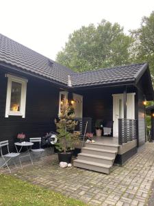 a black house with a porch and a patio at Yttermoveien in Narvik