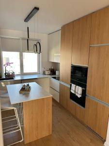a kitchen with wooden cabinets and a white counter top at Paradise Relax in Zalău