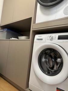a washer and dryer next to a washing machine at Paradise Relax in Zalău