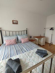a bed with two pillows on it in a bedroom at Mountain Nest Pirin in Razlog
