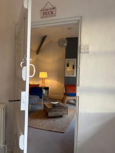 a room with a door open to a living room at Stylish Countryside Loft near Silverstone-Bicester in Buckingham