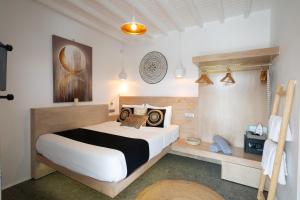 a bedroom with a large bed in a room at Double M Adults Only in Ano Mera
