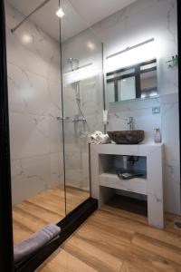 a bathroom with a glass shower and a sink at Double M Adults Only in Ano Mera