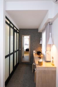 a kitchen with a counter and a hallway at Double M Adults Only in Ano Mera +18 photos
