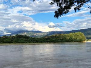 a view of a river with mountains in the background at Riveras Del Magdalena in Honda