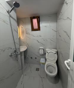 a bathroom with a toilet and a sink at Vila Vladmir Sela in Ksamil +20 photos