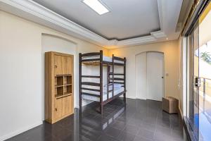 a room with bunk beds in it with a window at Sottam Hostel in Curitiba +29 photos