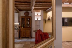 a living room with a mirror and a kitchen at La Casetta dei Forni in Radicofani +58 photos