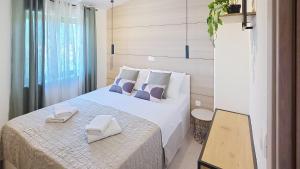 a bedroom with a bed with two towels on it at Apartments Grozdana in Baška