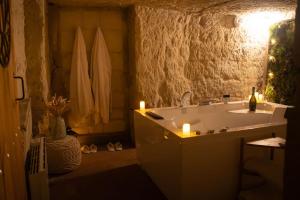 a bathroom with a sink and candles in it at Lantray Secrète in Les-Trois-Moutiers