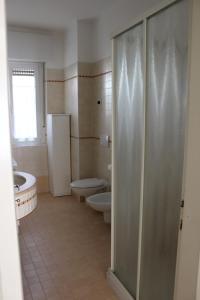 a bathroom with a shower and a toilet and a sink at la casa rosa in Breguzzo +15 photos