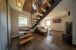 a living room with a staircase and a couch at Casa Frida in Manđelos