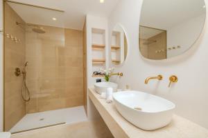 a bathroom with a sink and a shower at Antares Rooms and Suites in Olbia