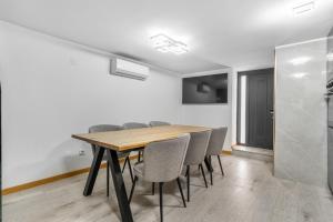 a dining room with a wooden table and chairs at Villa Jeronimo`s in Geres