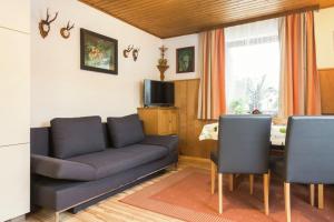 a living room with a couch and a table at Haus Osterrieder in Sankt Michael im Lungau