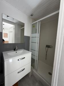 a bathroom with a white sink and a shower at Le petit port de boucain in Port-de-Bouc