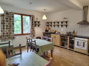 a kitchen and dining room with a table and chairs at Kentaur Guesthouse in Atea