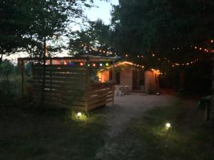 a house decorated with christmas lights at night at Chalet bucolique in Saint-Étienne-de-Chigny
