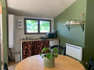 a small kitchen with a table and a sink at Chalet bucolique in Saint-Étienne-de-Chigny