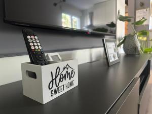 a remote control in a box on a table at Juga lux apartment in Fontana