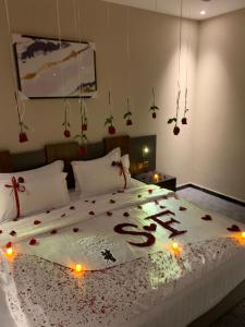 a bedroom with a large bed with lights on it at Belvedere Hotel in Medina