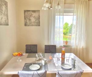 a dining room table with chairs and a large window at Ferienwohnung Schöne Aussicht in Nieheim