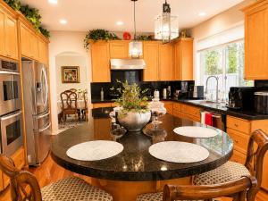 a kitchen with a table with chairs and a refrigerator at The Elegant & Cozy Retreat in Sammamish