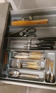 a drawer filled with utensils and other kitchen items at Light Home in Sodankylä
