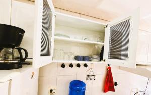 a kitchen with white cabinets and white appliances at Apto Completo próximo Aeroporto e Shopping in Várzea Grande