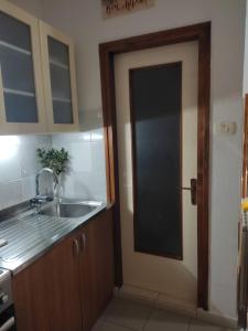 a kitchen with a door leading to a sink at Studio apartman Bari in Buzet