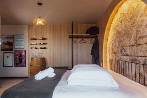 a bedroom with a large bed with a wooden wall at Pousada e Restaurante Del Miro in Nova Pádua