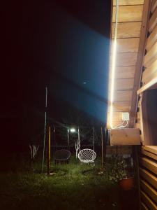 a backyard at night with two chairs and a table at Durmitor Hideaway in Žabljak