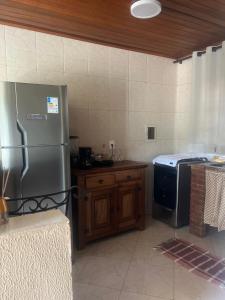 a kitchen with a stainless steel refrigerator and a stove at Beautiful view room in Angra dos Reis