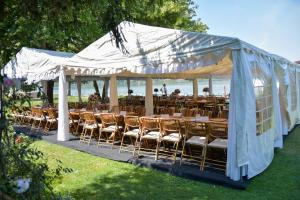 a group of tables and chairs under a tent at Casa Maria in Vrancea