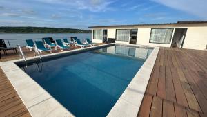 a swimming pool with lounge chairs on a deck at Casa Maria in Vrancea