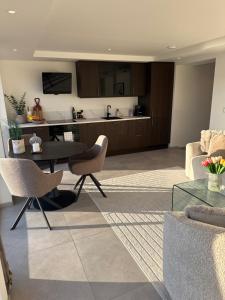 a living room with a table and chairs and a kitchen at Tromso Panorama in Tromsø